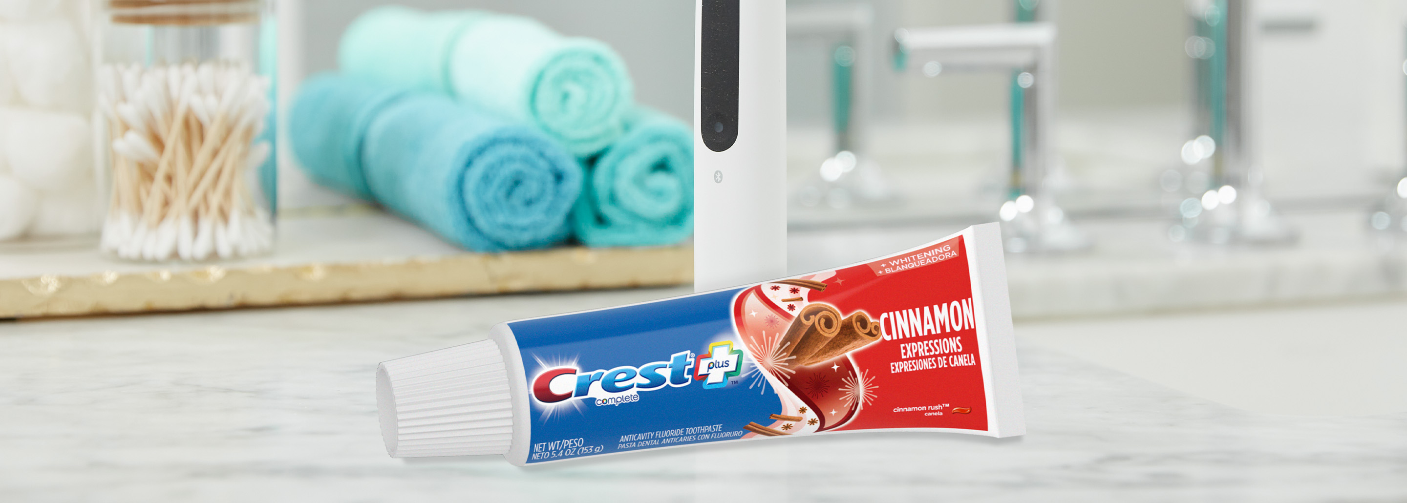 Clean vanity with an Oral-B iO Series Electric Toothbrush and Crest Cinnamon Expressions Toothpaste